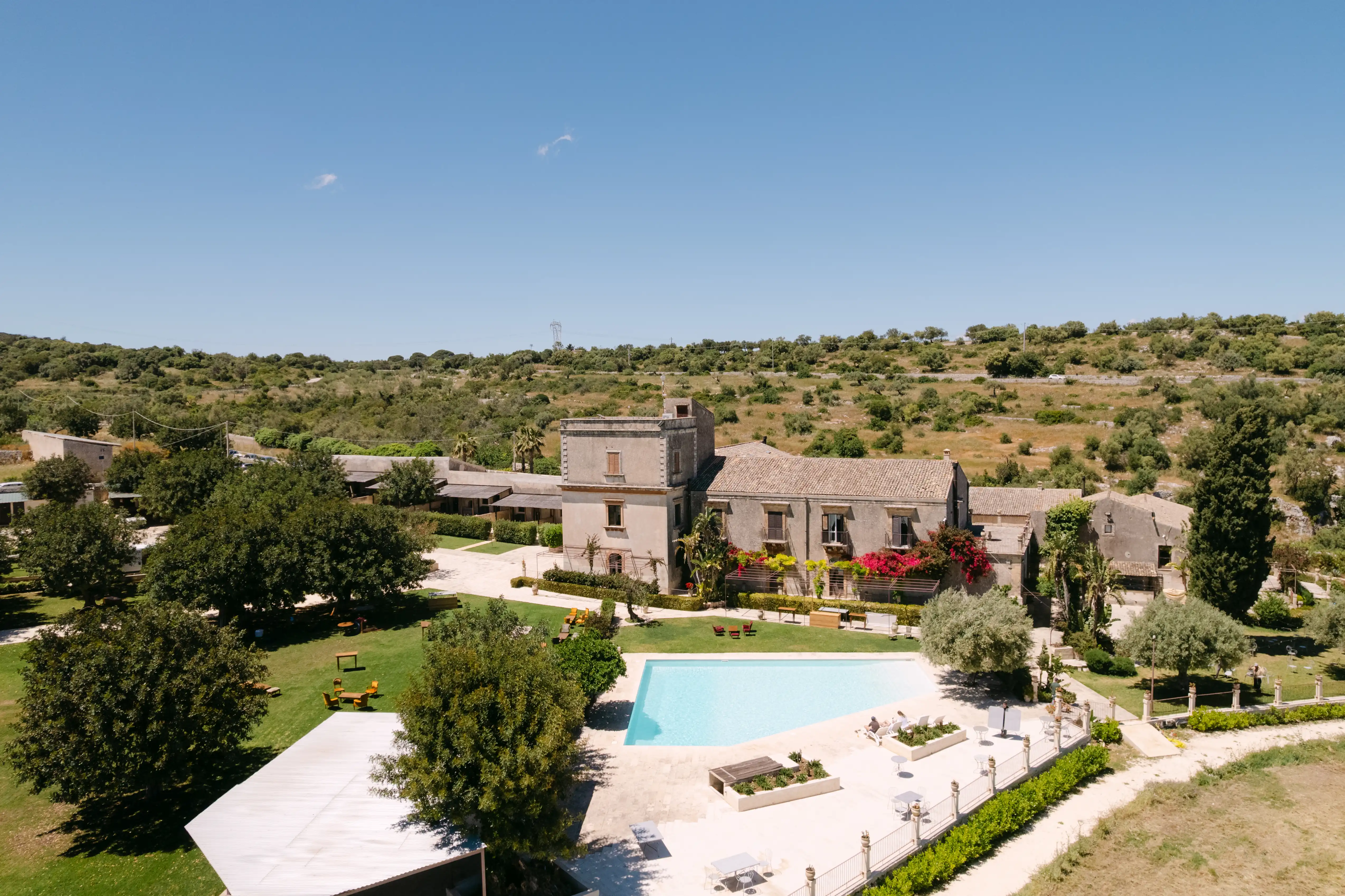 Luxury wedding venue in Sicily surrounded by Mediterranean countryside and elegant pool area